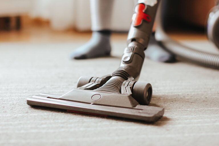 Carpet being vacuumed and cleaned with professionals